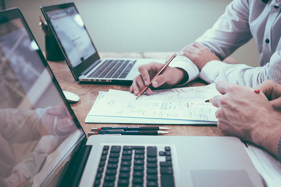 Two People doing a Psychometric Asessment with computers and documents